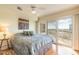 Bright main bedroom featuring hardwood floors, balcony access, and neutral tones at 2967 S Atlantic Ave # 708, Daytona Beach Shores, FL 32118