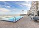 Outdoor swimming pool with patio and lounge chairs offering scenic views at 2967 S Atlantic Ave # 708, Daytona Beach Shores, FL 32118