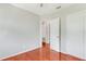 Bedroom with hardwood floors, closet, and an open door leading to another room, providing easy access and flow at 394 Golf Blvd, Daytona Beach, FL 32118