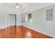 Bedroom with hardwood floors, closet, built in shelving and a window, providing storage and natural light at 394 Golf Blvd, Daytona Beach, FL 32118