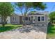 Charming home exterior with a well-maintained lawn and driveway, offering curb appeal and a welcoming ambiance at 394 Golf Blvd, Daytona Beach, FL 32118