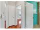 Hallway view with access to a bedroom and bathroom featuring hardwood floors and fresh paint at 394 Golf Blvd, Daytona Beach, FL 32118
