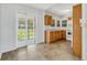 Bright kitchen featuring tile flooring, wooden cabinets, and an adjacent sunroom area at 394 Golf Blvd, Daytona Beach, FL 32118