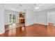 Spacious open-concept living room with hardwood floors, connecting to the kitchen and patio, ideal for entertaining at 394 Golf Blvd, Daytona Beach, FL 32118