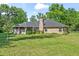 Brick house with a screened in porch and a large backyard at 4008 Acoma Dr, Ormond Beach, FL 32174