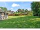 Spacious backyard with a well-maintained lawn, wood fence, and mature trees at 4008 Acoma Dr, Ormond Beach, FL 32174