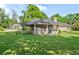 Brick house with a screened in porch and a large backyard at 4008 Acoma Dr, Ormond Beach, FL 32174