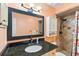 Bathroom with granite counters, decorative mirror, and tiled shower with shower head at 4008 Acoma Dr, Ormond Beach, FL 32174