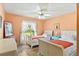 Bright bedroom featuring two twin beds, tile floors, and natural light at 4008 Acoma Dr, Ormond Beach, FL 32174