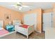 Cozy bedroom with tile flooring, closet, and two twin beds with orange throw blankets at 4008 Acoma Dr, Ormond Beach, FL 32174