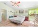 Bright bedroom with ceiling fan, natural light, and tile floors, enhancing the home's relaxing atmosphere at 4008 Acoma Dr, Ormond Beach, FL 32174