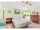 Cozy bedroom featuring a ceiling fan, natural light, and neutral tones creating a relaxing atmosphere at 4008 Acoma Dr, Ormond Beach, FL 32174