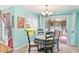 Cozy dining area with bright natural light, chandelier, and sliding door access at 4008 Acoma Dr, Ormond Beach, FL 32174