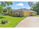 Brick house with a spacious driveway and a yellow garage door at 4008 Acoma Dr, Ormond Beach, FL 32174