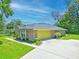 Brick house with a spacious driveway and a yellow garage door at 4008 Acoma Dr, Ormond Beach, FL 32174