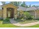 Inviting front entrance with a brick archway and a glass-paneled door at 4008 Acoma Dr, Ormond Beach, FL 32174