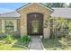 Inviting front entrance with a brick archway and a glass-paneled door at 4008 Acoma Dr, Ormond Beach, FL 32174