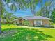 Beautiful one story home with mature trees and a green lawn in a serene setting at 4008 Acoma Dr, Ormond Beach, FL 32174