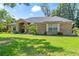 Charming one story brick home with a well-manicured lawn and mature landscaping at 4008 Acoma Dr, Ormond Beach, FL 32174