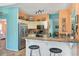 Spacious kitchen with stainless appliances, granite countertops, and bar seating opens to the dining and living areas at 4008 Acoma Dr, Ormond Beach, FL 32174