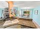 Kitchen featuring granite counters and travertine floors with a pass-through that opens to the dining and living rooms at 4008 Acoma Dr, Ormond Beach, FL 32174