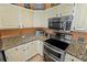 Bright kitchen with stainless steel appliances and granite countertops offering plenty of space to prepare gourmet meals at 4008 Acoma Dr, Ormond Beach, FL 32174