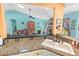 Open kitchen with granite counters and a pass-through offering views into the living room with a fireplace and vaulted ceilings at 4008 Acoma Dr, Ormond Beach, FL 32174