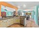 Stylish kitchen featuring granite countertops, stainless steel appliances, and a pass-through to the living and dining area at 4008 Acoma Dr, Ormond Beach, FL 32174