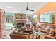 Cozy living room with a brick fireplace, comfortable seating, and an open layout at 4008 Acoma Dr, Ormond Beach, FL 32174