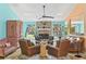 Comfortable living room featuring a brick fireplace, seating, and stylish decor at 4008 Acoma Dr, Ormond Beach, FL 32174