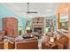 Bright living room featuring a brick fireplace, comfortable seating, and stylish decor at 4008 Acoma Dr, Ormond Beach, FL 32174