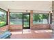 Covered porch with brick accents, tile flooring and views of the landscaped backyard, perfect for outdoor relaxation at 4008 Acoma Dr, Ormond Beach, FL 32174