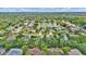 High-angle aerial view of community displaying neighborhood, a lake, mature trees, and green spaces at 518 Moon Rise Dr, Port Orange, FL 32127