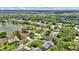 Panoramic aerial view of the neighborhood displaying mature trees, lake, and the surrounding areas at 518 Moon Rise Dr, Port Orange, FL 32127