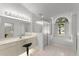 Well-lit bathroom showcasing a walk-in shower, tub, sink and garden window at 518 Moon Rise Dr, Port Orange, FL 32127