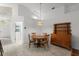 Dining area featuring tile flooring, a wood dining set and a decorative hanging light fixture at 518 Moon Rise Dr, Port Orange, FL 32127