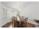 Dining room with wood floors and a dark wood table and seating for six at 518 Moon Rise Dr, Port Orange, FL 32127