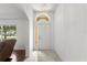 Bright foyer featuring tile flooring, a sidelight window, and an arched transom above the front door at 518 Moon Rise Dr, Port Orange, FL 32127