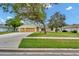 Inviting one-story home with a well-maintained lawn, mature trees, and an attached two-car garage at 518 Moon Rise Dr, Port Orange, FL 32127