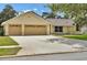 Charming one-story home with a spacious driveway, attached two-car garage, and well-manicured lawn at 518 Moon Rise Dr, Port Orange, FL 32127