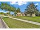 Charming one-story home with a wide driveway, attached two-car garage, and lush green lawn in a sunny setting at 518 Moon Rise Dr, Port Orange, FL 32127