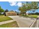 Charming one-story home with a wide driveway, attached two-car garage, and lush green lawn in a sunny setting at 518 Moon Rise Dr, Port Orange, FL 32127