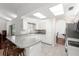Bright kitchen with white cabinets, light countertops, an arched doorway and stainless steel appliances at 518 Moon Rise Dr, Port Orange, FL 32127