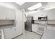 Kitchen featuring white cabinets, stainless steel appliances and light countertops with tile flooring at 518 Moon Rise Dr, Port Orange, FL 32127