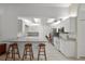 Kitchen featuring tile floors, gray counters and a bar area with seating at 518 Moon Rise Dr, Port Orange, FL 32127