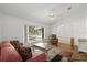 Bright living room with a large window, ceiling fan, and cozy seating arrangement at 518 Moon Rise Dr, Port Orange, FL 32127