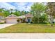 Charming single-story home with a well-maintained lawn, mature trees, and an attached two-car garage at 5313 Georgia Peach Ave, Port Orange, FL 32128