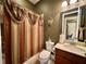 A well-lit bathroom with a patterned shower curtain at 745 Aldenham Ln, Ormond Beach, FL 32174