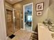 A modern bathroom with a glass-enclosed shower and neutral tile at 745 Aldenham Ln, Ormond Beach, FL 32174