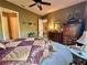 The bedroom has beautiful hardwood furniture, an area rug, and a ceiling fan at 745 Aldenham Ln, Ormond Beach, FL 32174